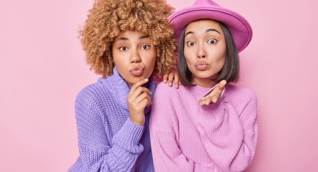 women posing in a photobooth